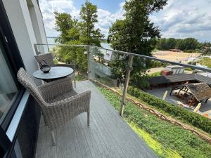 a balcony with a table and chairs on a house at Horizon Park 33 Boszkowo in Boszkowo +3 photos