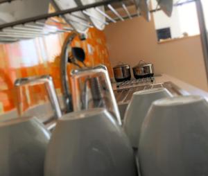 a kitchen with four white urinals in front of a stove at The Rock Hostel in Matera