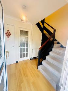 a stairway in a home with a stair case at Unnati stay in Buckinghamshire