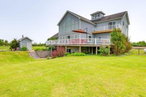 a large house with a lawn in front of it at The Gathering Place Rushville Home with Hot Tub in Rushville