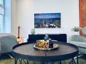 a table with a plate of food on top of it at Elegant Three-Bedroom Apartment with Stunning Sea Views - Very limited availability - Secure your booking for Christmas 2026 or Summer 2027 in Ålesund