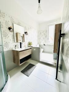 a white bathroom with a sink and a mirror at Adora B&B in Vezzano Ligure