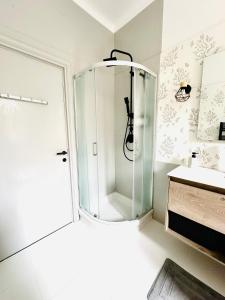 a glass shower in a bathroom with a sink at Adora B&B in Vezzano Ligure +22 photos