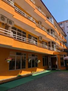 a building with balconies on the side of it at Vila njoy by the sea in Eforie Sud
