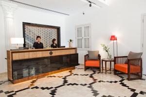 two women sitting at a reception desk in a lobby at The Sultan in Singapore