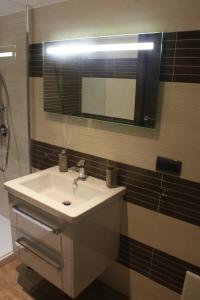 a bathroom with a sink and a mirror at Terrazzi in Fiore in Alghero