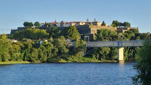 a bridge over a river with houses on a hill at CASITA RECIEN HABILITADA A ESTRENAR CON PISCINA EN MALVAS Tuy in Malvas