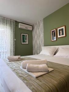 two beds in a bedroom with green walls at Villa Marie in Baška Voda