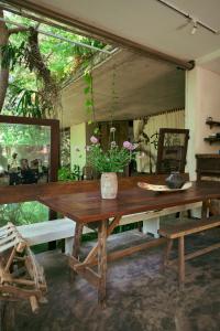 a wooden table with a potted plant on top of it at Kyara Arthouse Villa in Thanh Ðông (1)