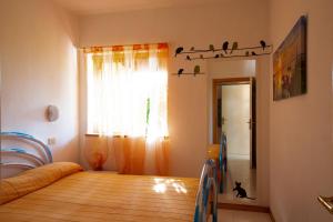 A bed or beds in a room at Porto Coda Cavallo Salina Bamba