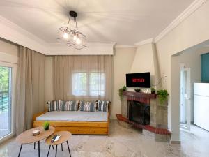 a living room with a bed and a fireplace at House 2BD Private Parking Next to Center in Asprovalta
