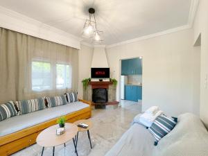 a living room with a couch and a fireplace at House 2BD Private Parking Next to Center in Asprovalta