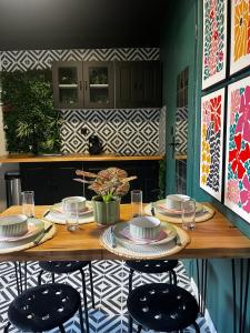 a wooden table with chairs and plates on it at Atelier de Lisa in Forbach +9 photos