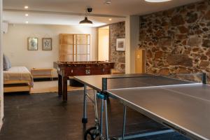 a room with a ping pong table and a bedroom at Real Villa I by Mycelia 