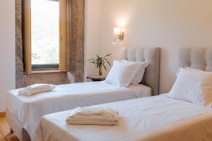 two beds sitting next to each other in a room at Real Villa I by Mycelia  +111 photos