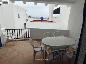 a table and chairs on a balcony with the ocean at Cabo house in Cabo Negro