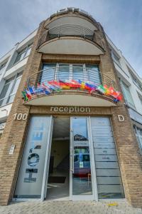 a building with a store front with colorful umbrellas at Hotel Samaria in Šamorín