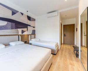 Katil atau katil-katil dalam bilik di Monun Hotel