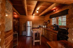 a kitchen with wooden walls and a refrigerator at Lyford Luxury Escape - ML21963 in Mt Lyford