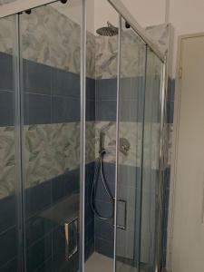 a shower with a glass door in a bathroom at A casa di paola in Naples