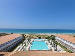 an aerial view of the pool and the beach at Iberostar Selection Andalucia Playa in Chiclana de la Frontera