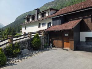 a large house with a garage and a building at Ferienwohnung Annamaria und Manuel Melmer in Sankt Leonhard im Pitztal