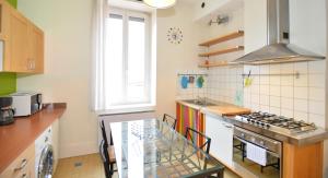 a kitchen with a glass table in a kitchen at Appart' Recamier in Lyon