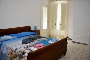 a bedroom with a bed with clothes on it at Casetta Virginia in Ischia