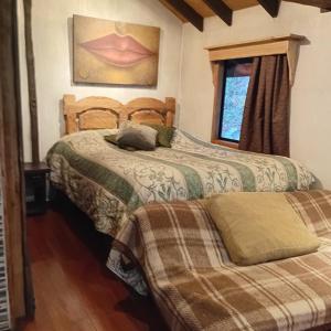 a bedroom with two beds and a window at Pucón Volcano Forest SPA in Pucón