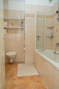 a bathroom with a shower and a tub and a toilet at Burhan in Hamburg