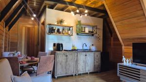 a kitchen with wooden walls and a table and a counter at Chalé Sol in Blumenau