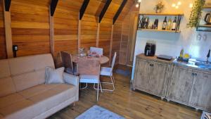 a living room with a couch and a table at Chalé Sol in Blumenau +13 photos