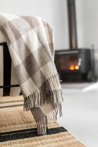 a blanket is draped over the edge of a rug at The Reads Freycinet - Water Front Property in Coles Bay