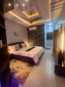 a bedroom with a king sized bed with a wall at Private in Dargai +3 photos