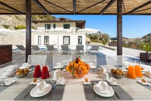 a dining table with fruit on top of a house at Villa Zagara in Savoca