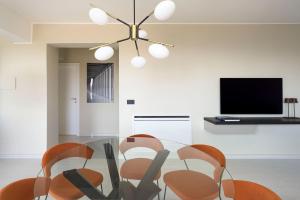 a dining room with a glass table and chairs at Villa Zagara in Savoca