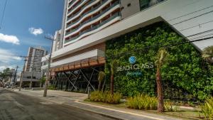 ein Gebäude mit einer grünen Wand an der Seite in der Unterkunft Studio 25 andar a 350m da Beira Mar com Rooftop in Fortaleza