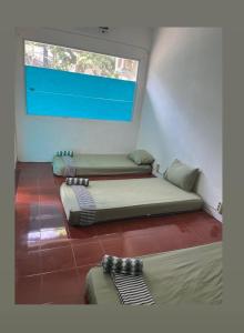 Postel nebo postele na pokoji v ubytování Hijau Hostel