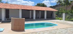 a small swimming pool in front of a house at A few kilometers from banana plantations in Belém +1 photo