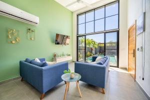 a living room with two blue couches and a tv at Casa Encanto -beautiful Home in Potrero