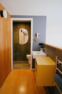 a bathroom with a sink and a toilet and a mirror at Kowhai Studio -private opposite golf course in central Wanaka in Wanaka +17 photos