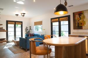 a living room with a table and chairs at Spanish-style garden Bungalow in Burbank +2 photos