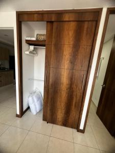 a large wooden cabinet in a room with at Apartamento Loft con vista unica in Itagüí +17 photos