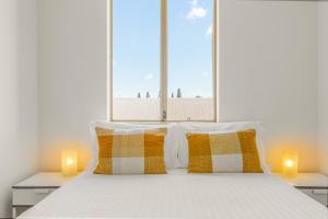 a bedroom with a large bed with two candles at Central Fremantle Lifestyle walk to markets, cafe, bars in Fremantle
