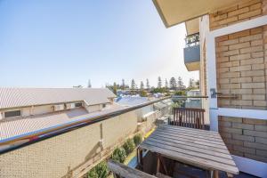 a balcony with a wooden bench on a building at Central Fremantle Lifestyle walk to markets, cafe, bars in Fremantle