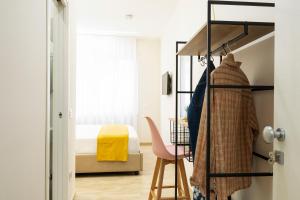 a bedroom with a bunk bed and a desk and a chair at N'Ador Rooms in Naples