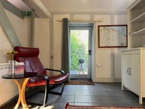 a living room with a dog looking out the door at Barnacle Barn, North Norfolk in Roughton