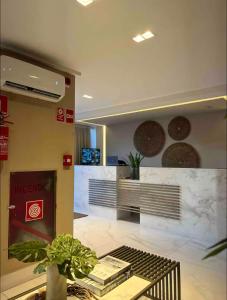 a lobby of aarmaarma store with a potted plant at Buenos Ayres Flats, Cabo Branco 1qto cozinha completa in João Pessoa +73 photos