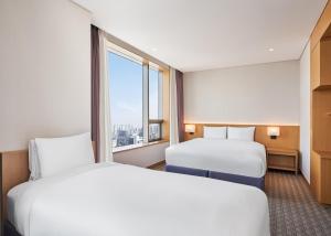 Postel nebo postele na pokoji v ubytování Sotetsu Hotels The Splaisir Seoul Dongdaemun