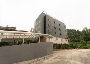 a tall building with a parking lot in front of it at Hotel Diamant in Seoul +7 photos